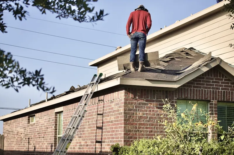 Professional roofer working on a residential roof in Wayne